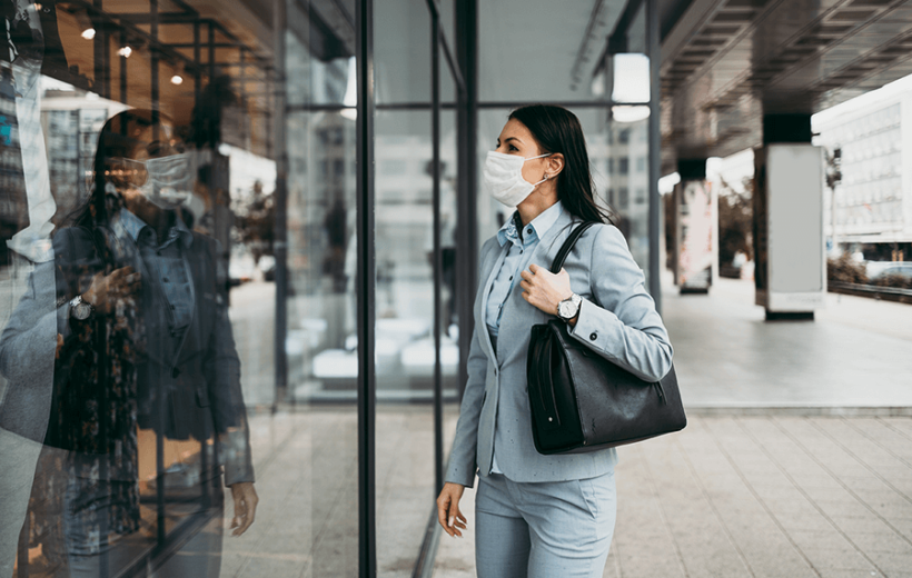 Woman in mask entering office