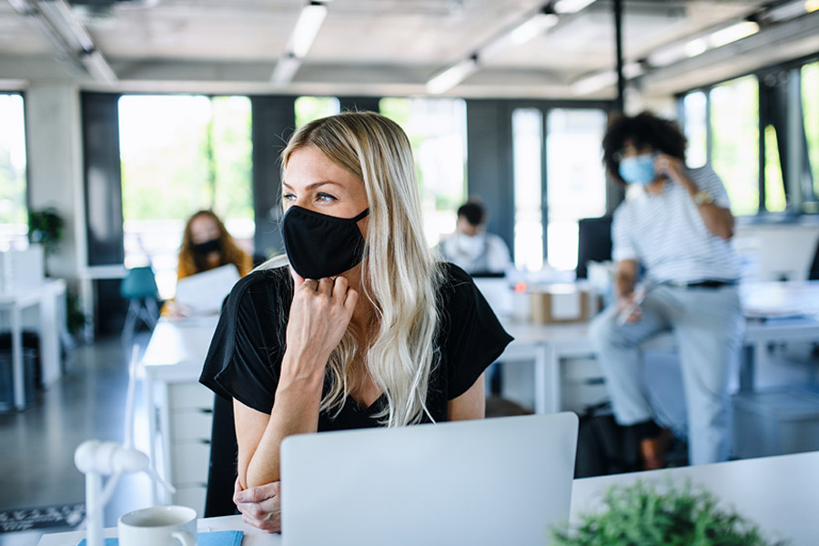 Woman in Mask Working at Desk