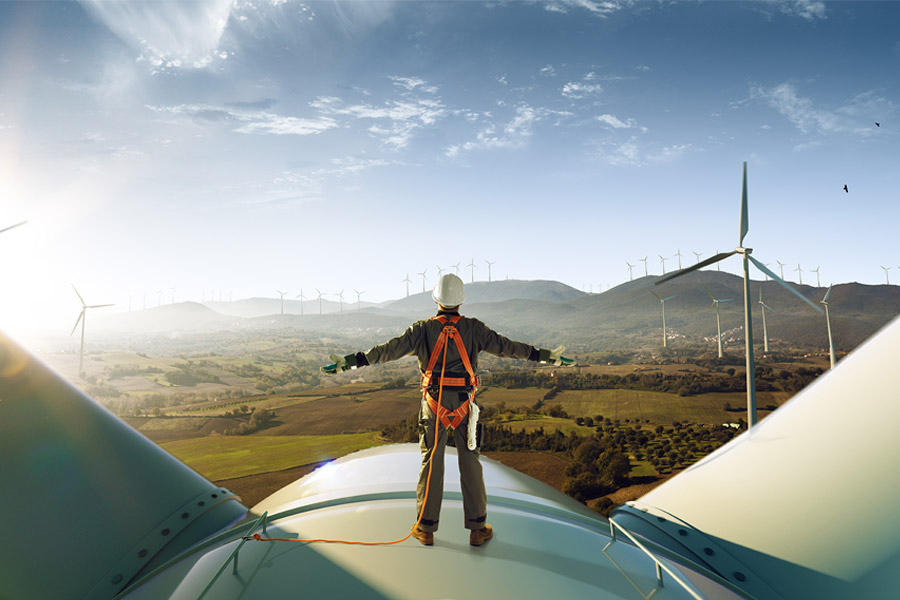 Man Standing On Wind Turbine