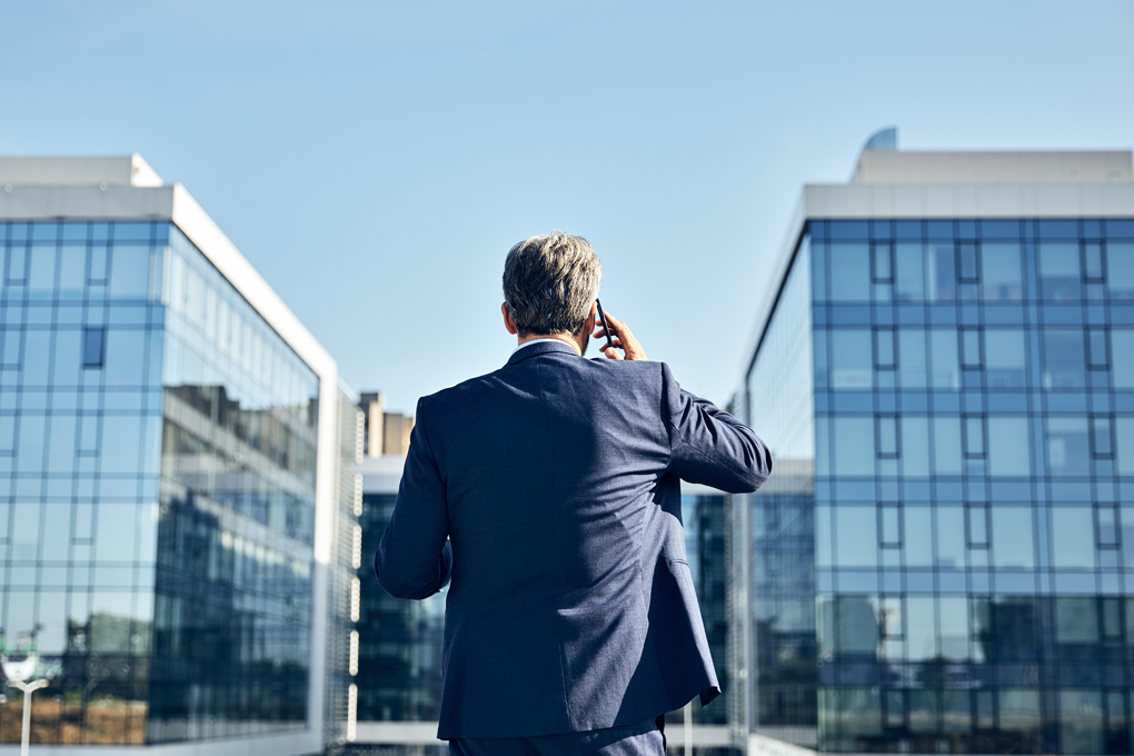 Man Standing Between Two Smart Buildings